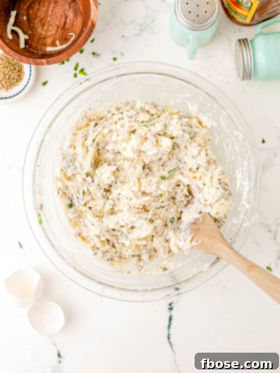 Ricotta and meat pasta filling mixture in a bowl, showing the texture and blend of ingredients.