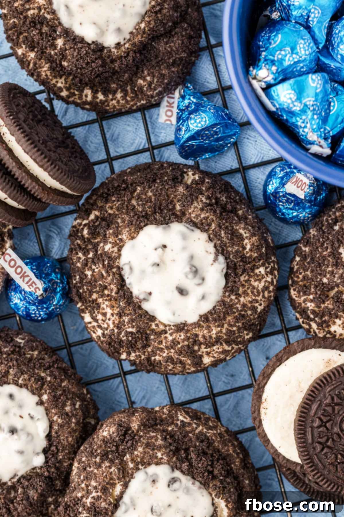 Overhead photo of Oreo thumbprint cookies cooling on a wire rack, showcasing their perfect shape and topping.