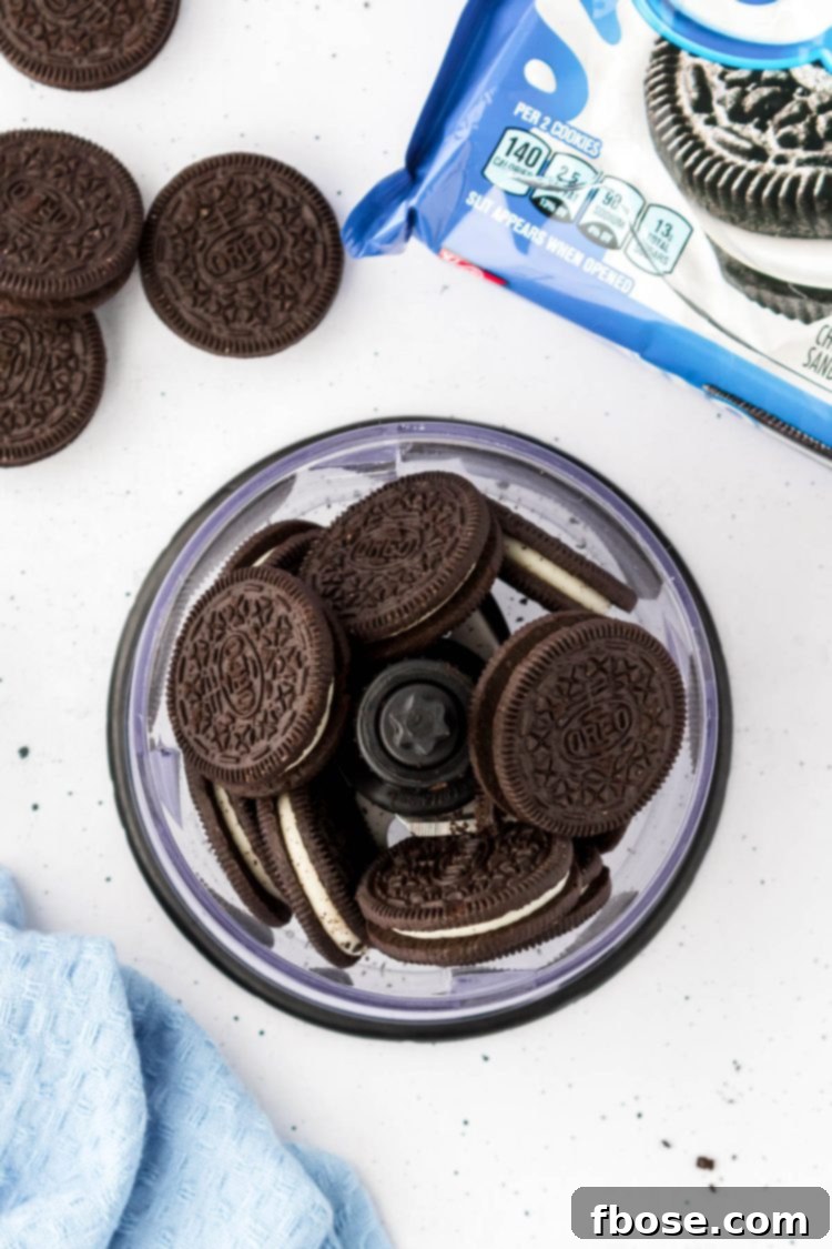 Overhead photo of Oreos being pulsed in a food processor to create fine crumbs.