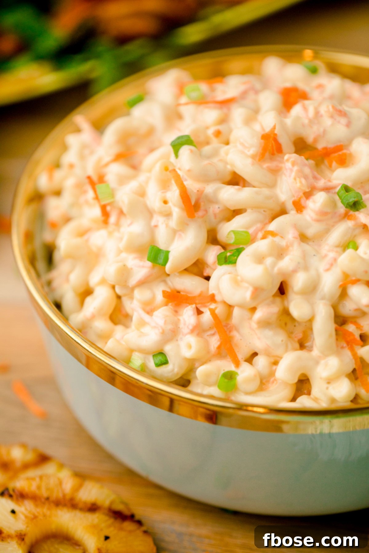 Close-up photo of a spoonful of creamy Hawaiian macaroni salad.