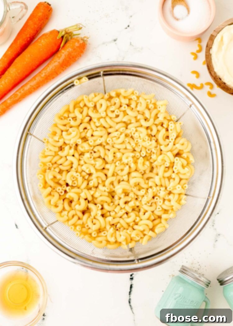 Macaroni in a strainer after being cooked.