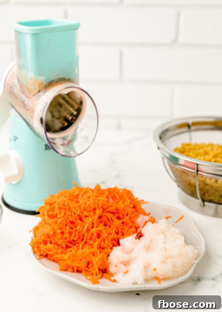 Grated carrots and onion on a plate, ready to be added to the salad.