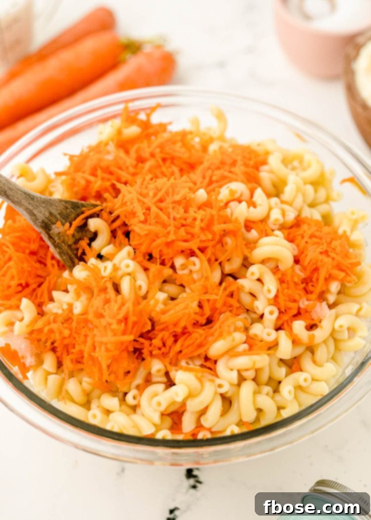 Hawaiian Pasta Salad being prepared in a large mixing bowl.