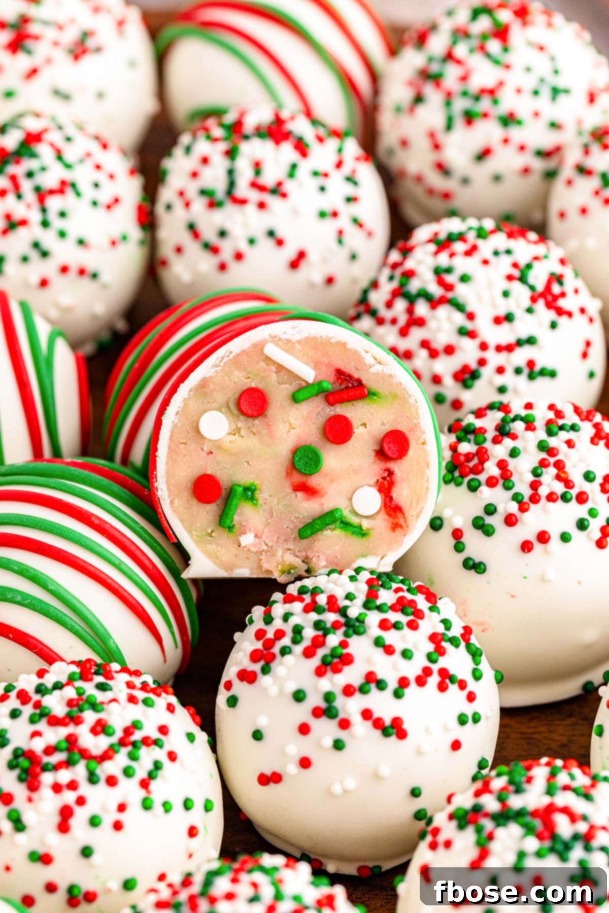 Close up of Christmas Sugar Cookie Truffles piled on a plate, featuring their vibrant colors and festive sprinkles.