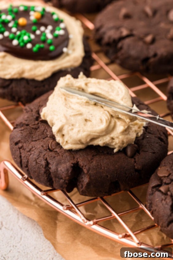 Irish cream frosting being added to chocolate cookies.