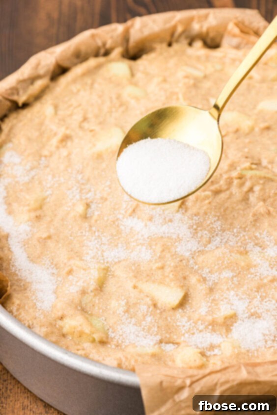 Sugar is sprinkled on top of a cake.
