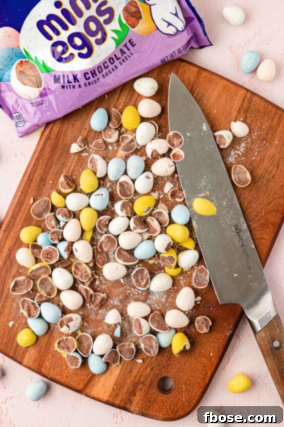Molten Cadbury Egg Brownies 16 Chopped Mini Cadbury Eggs on a cutting board with a knife.