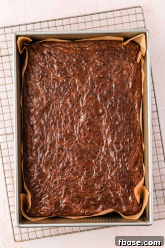Molten Cadbury Egg Brownies 19 Baked brownies cooling in a pan on a wore rack.