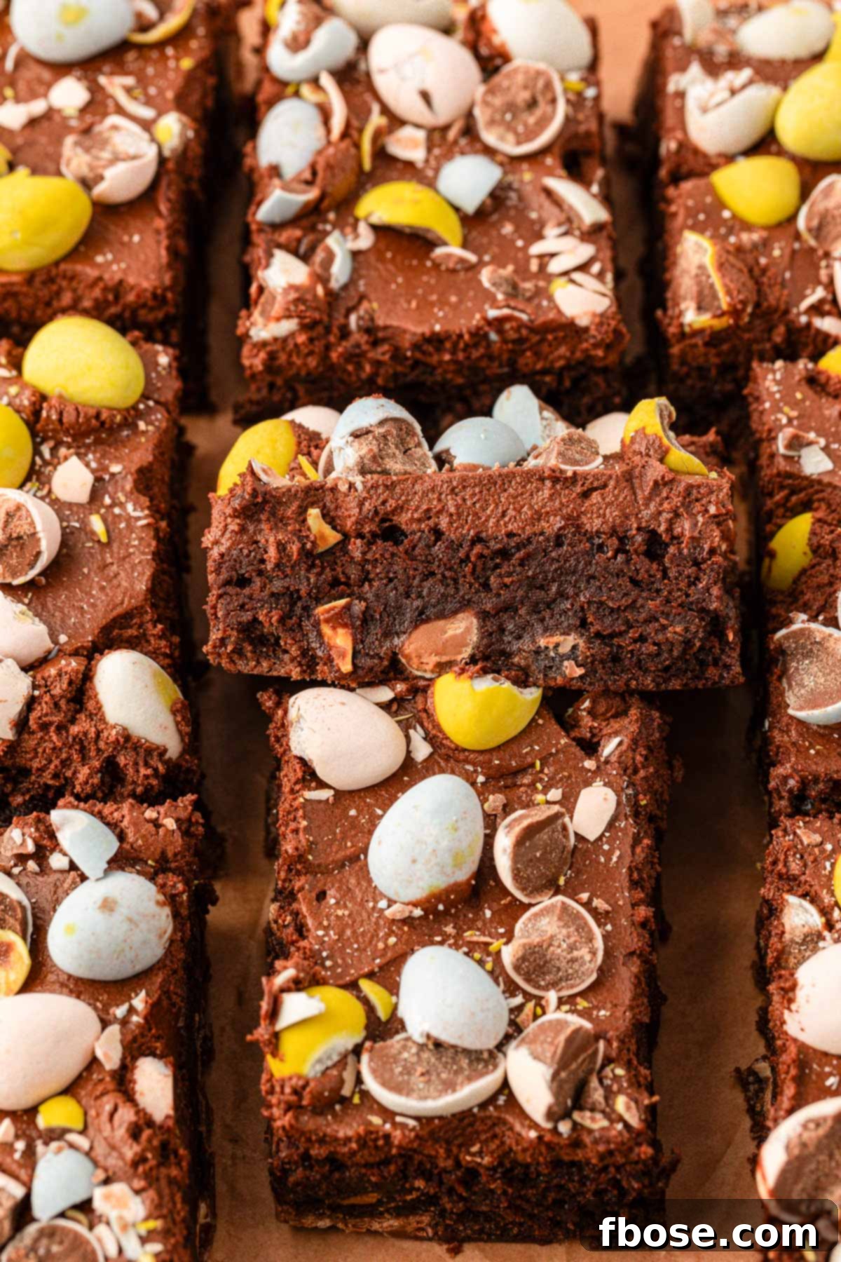 Molten Cadbury Egg Brownies 4 Perfectly sliced Cadbury Egg Brownies arranged on a stylish serving board, ready to be enjoyed.