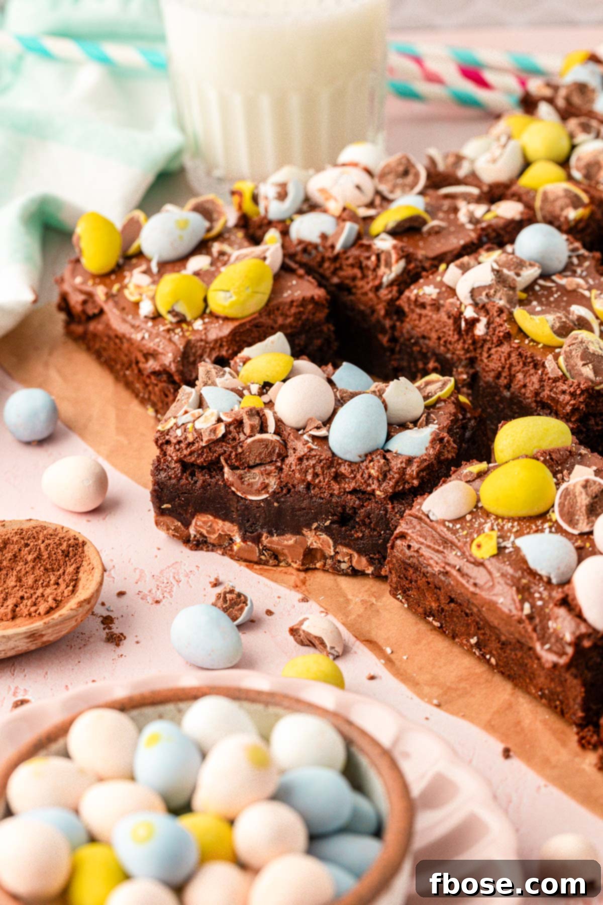Molten Cadbury Egg Brownies 6 Freshly cut brownies arranged on a piece of parchment paper, showcasing their perfect squares.