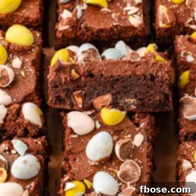 Molten Cadbury Egg Brownies 10 Sliced cadbury egg brownies on a serving board.