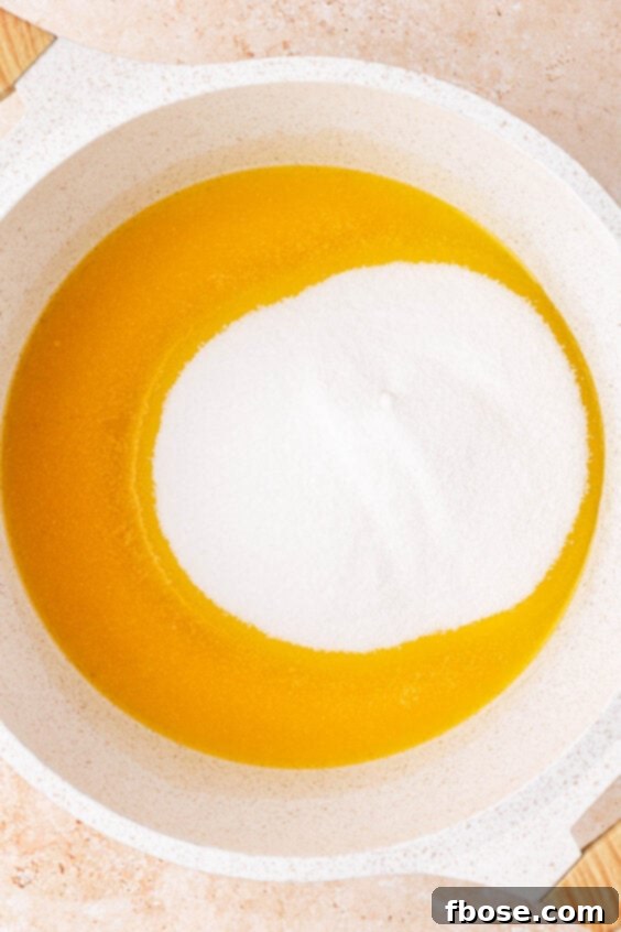 Sugar is added to melted butter in a saucepan.