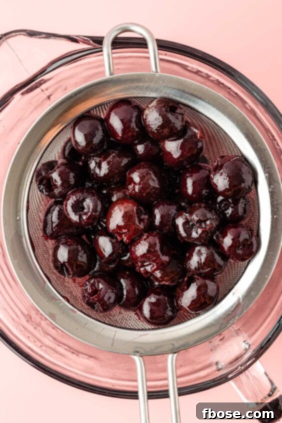Cherry simple syrup being strained.