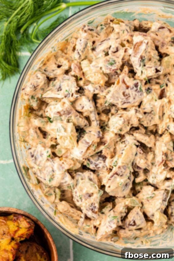 Smashed potato salad in a bowl.