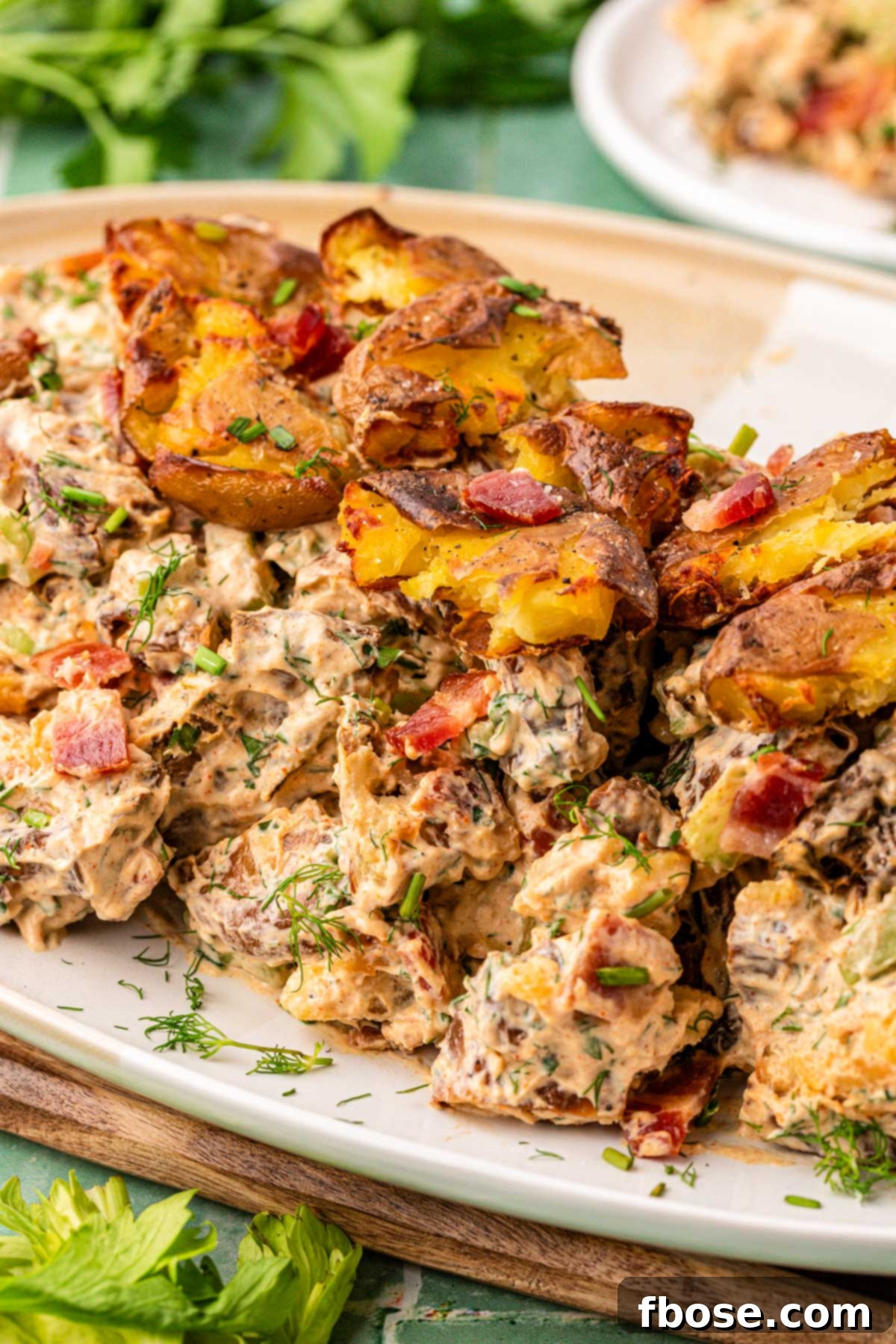A plate of smashed potato salad ready to be served.
