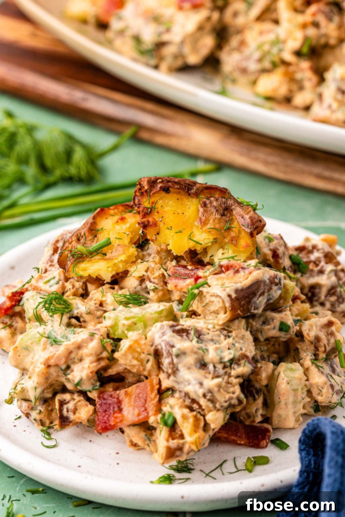 Close up of a serving of crispy potato salad on a plate.