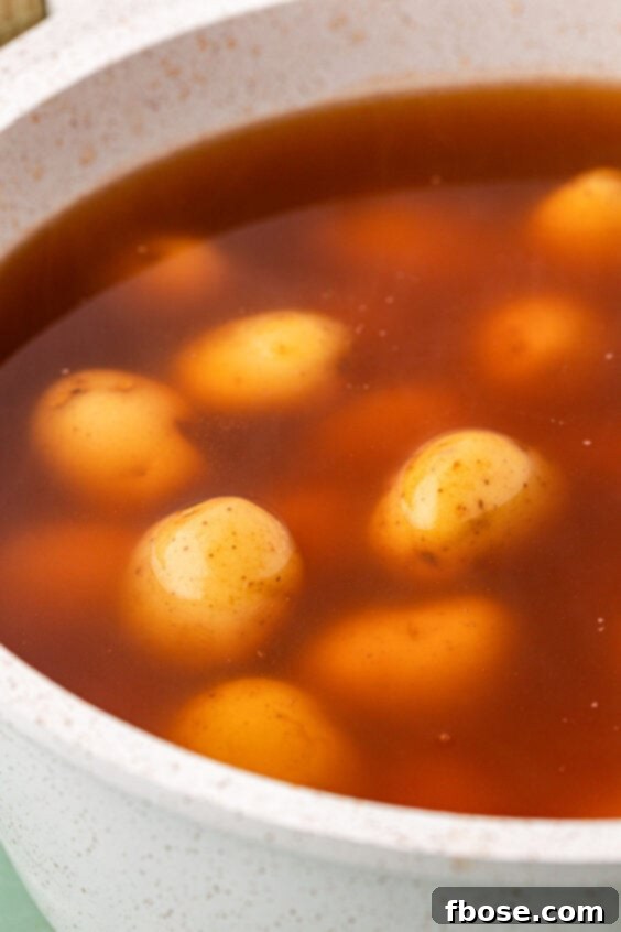 Baby potatoes boiling in seasoned water.
