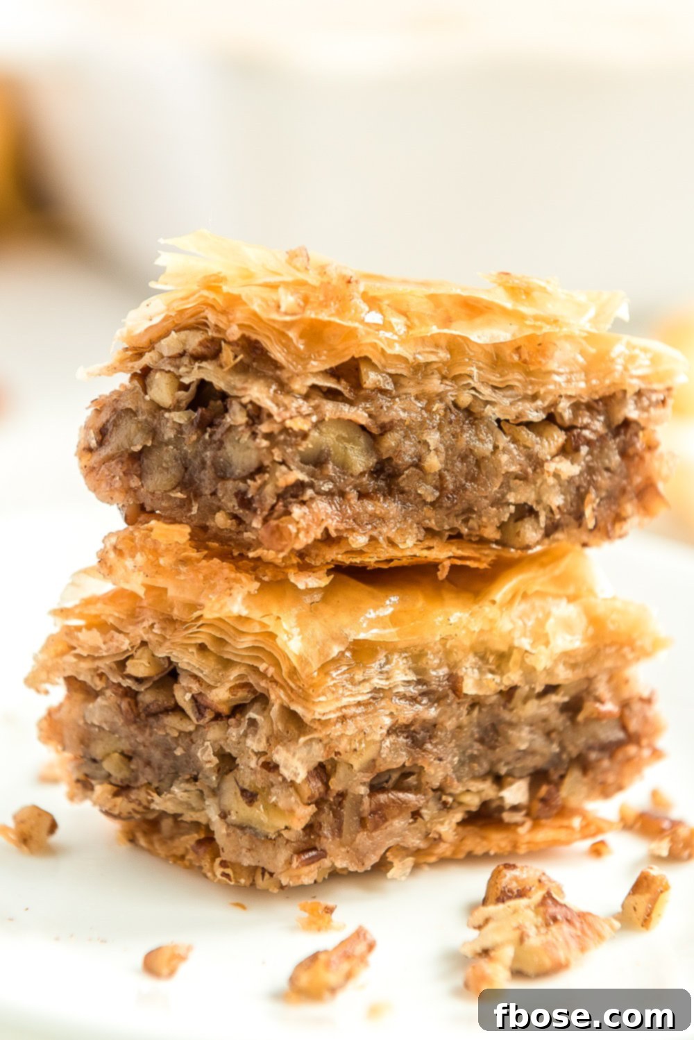 Effortless Homemade Baklava 2 Two pieces of Baklava stacked on top of each other.