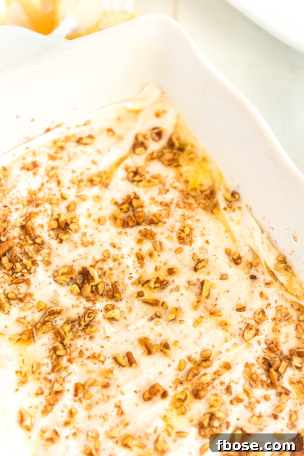 Effortless Homemade Baklava 7 Nut and spice mixture has been sprinkled over buttered phyllo dough.