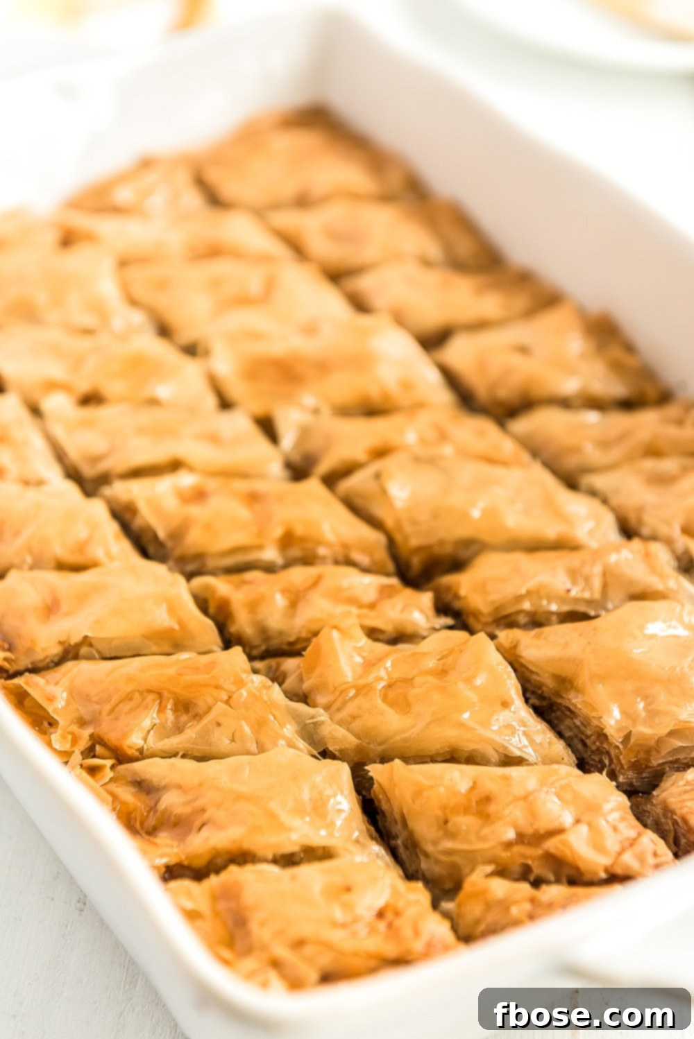 Effortless Homemade Baklava 9 Baked baklava in a white baking dish.