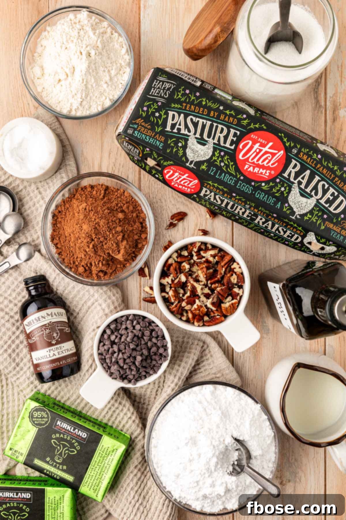 Overhead photo of ingredients to make Texas Sheet Cake brownies on a wooden table, showcasing fresh, quality components.