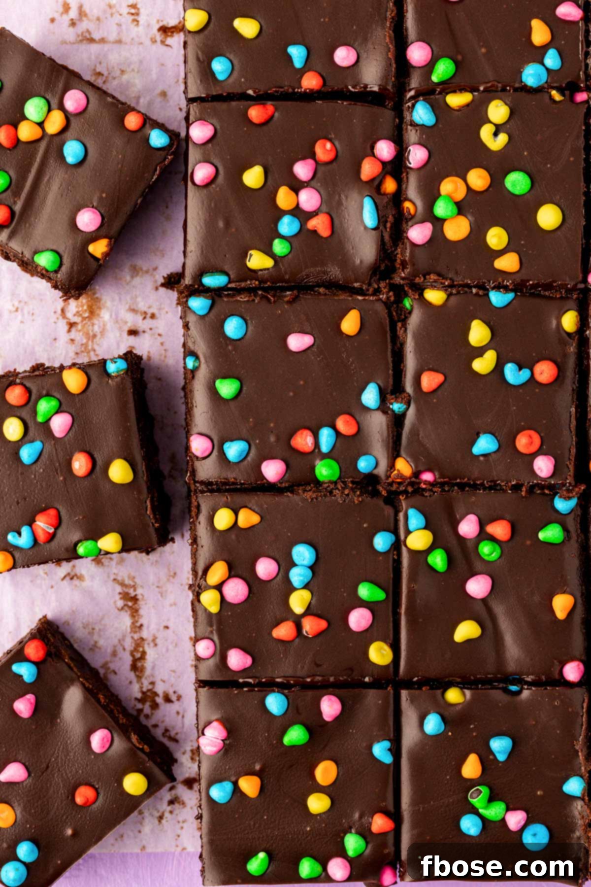Homemade cosmic brownies sliced on a table, showcasing their fudgy texture and colorful sprinkles.