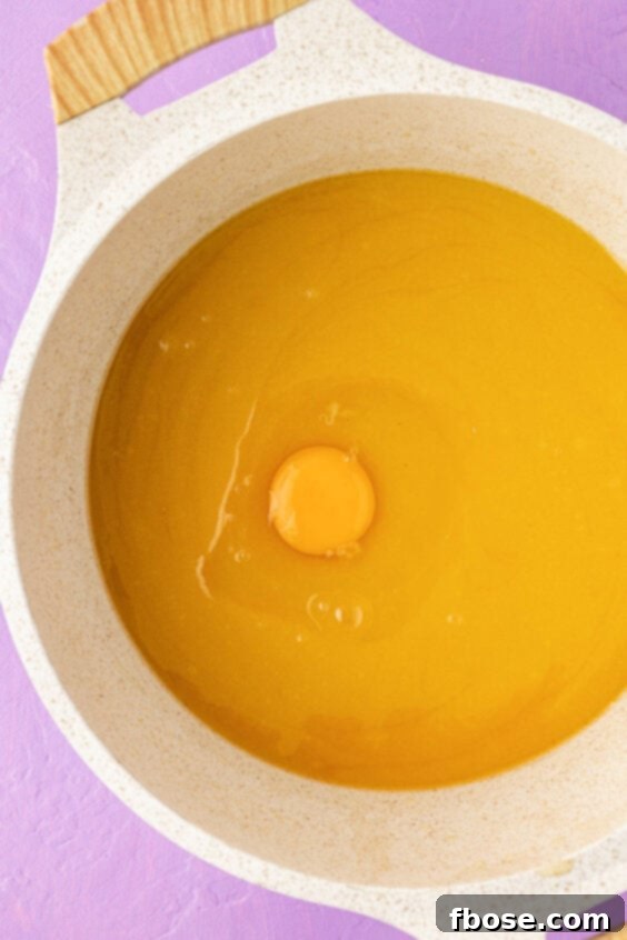 Egg in a pot with melted butter and sugar.