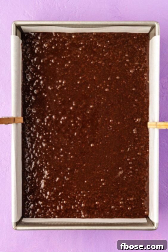 Brownie batter ready to be baked in a 9x13-inch pan.