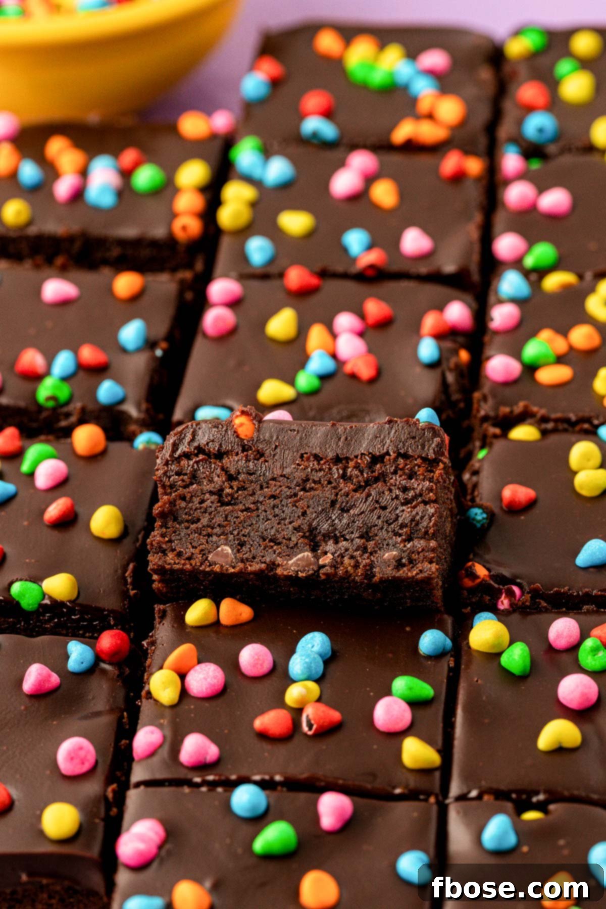 Cosmic brownies that are homemade, cut into squares on a table.