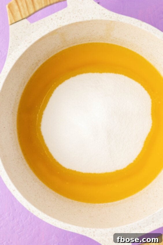Sugar being added to a pot with sugar and butter.
