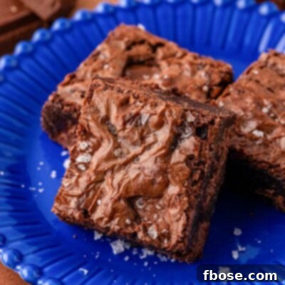 Close up of a pan of chocolate brownies on a blue plate.