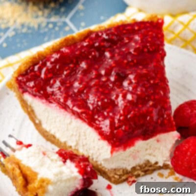 A slice of raspberry cream pie with a bite missing on a plate.