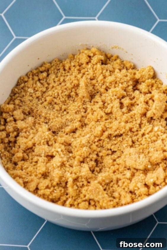 Graham cracker crust mixture in a white bowl.