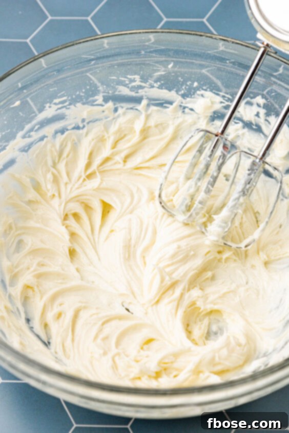 Cream cheese and sugar beaten in a mixing bowl.