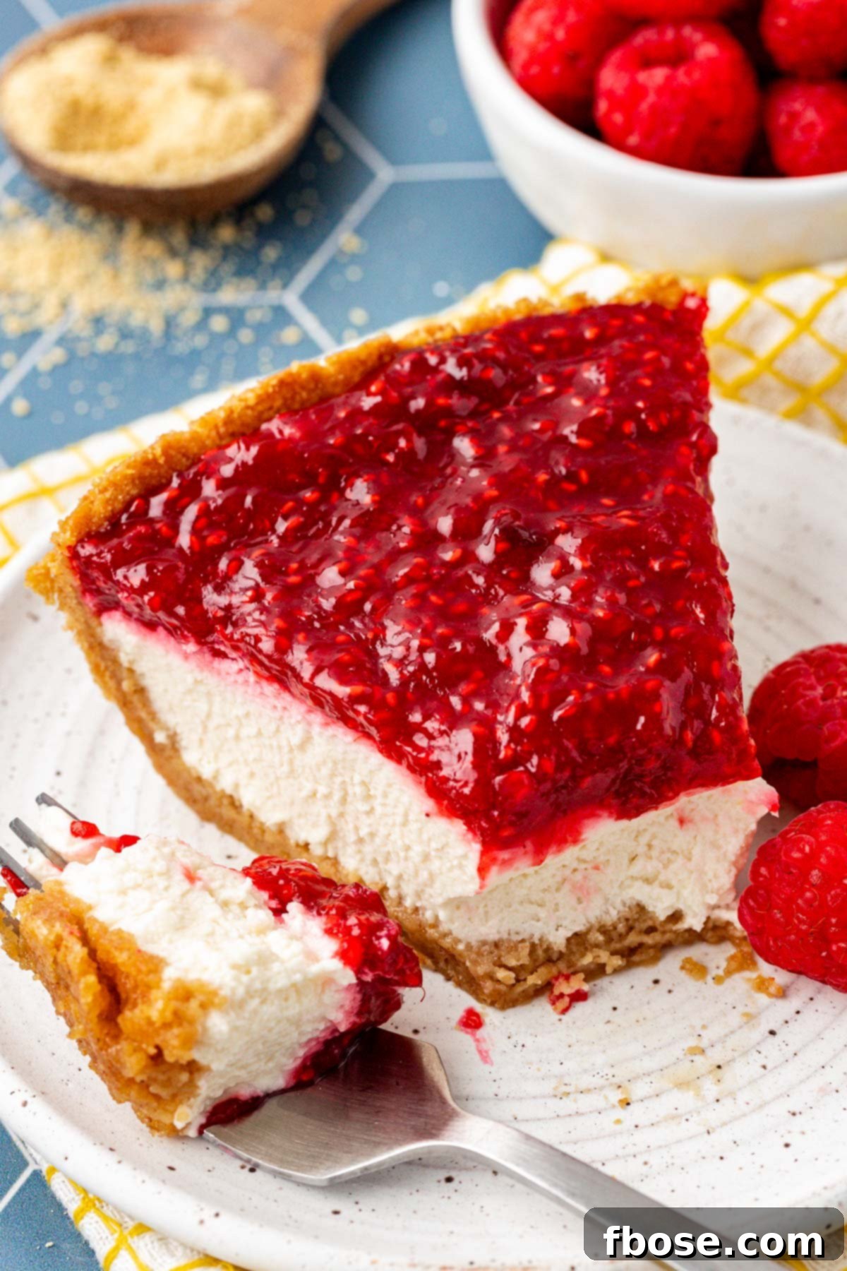 A tantalizing slice of raspberry cream pie with a bite missing, tempting any dessert lover.