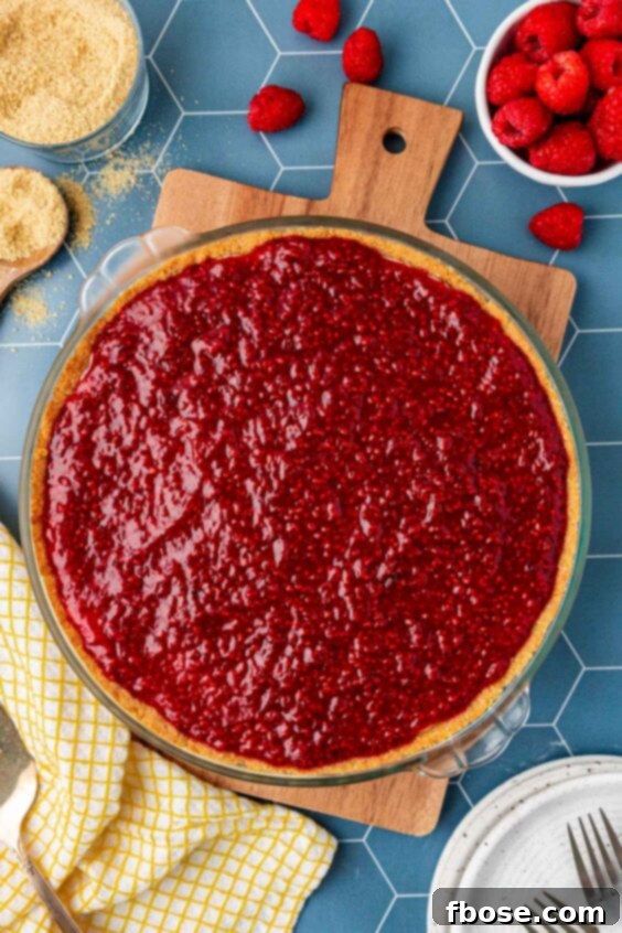 Raspberry cream pie on a serving board.