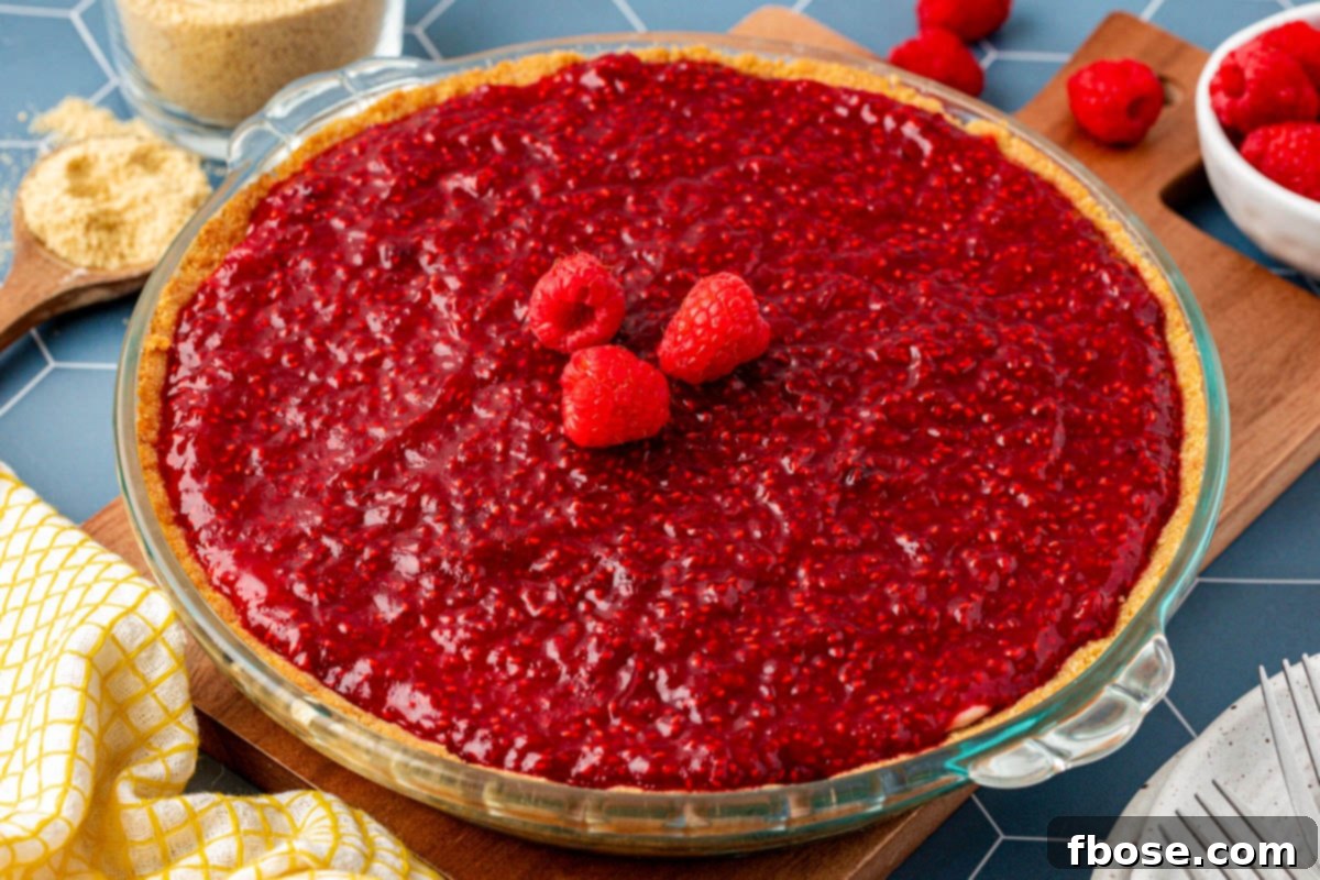 Close up of a vibrant No Bake Raspberry Cream Pie, ready to be served.