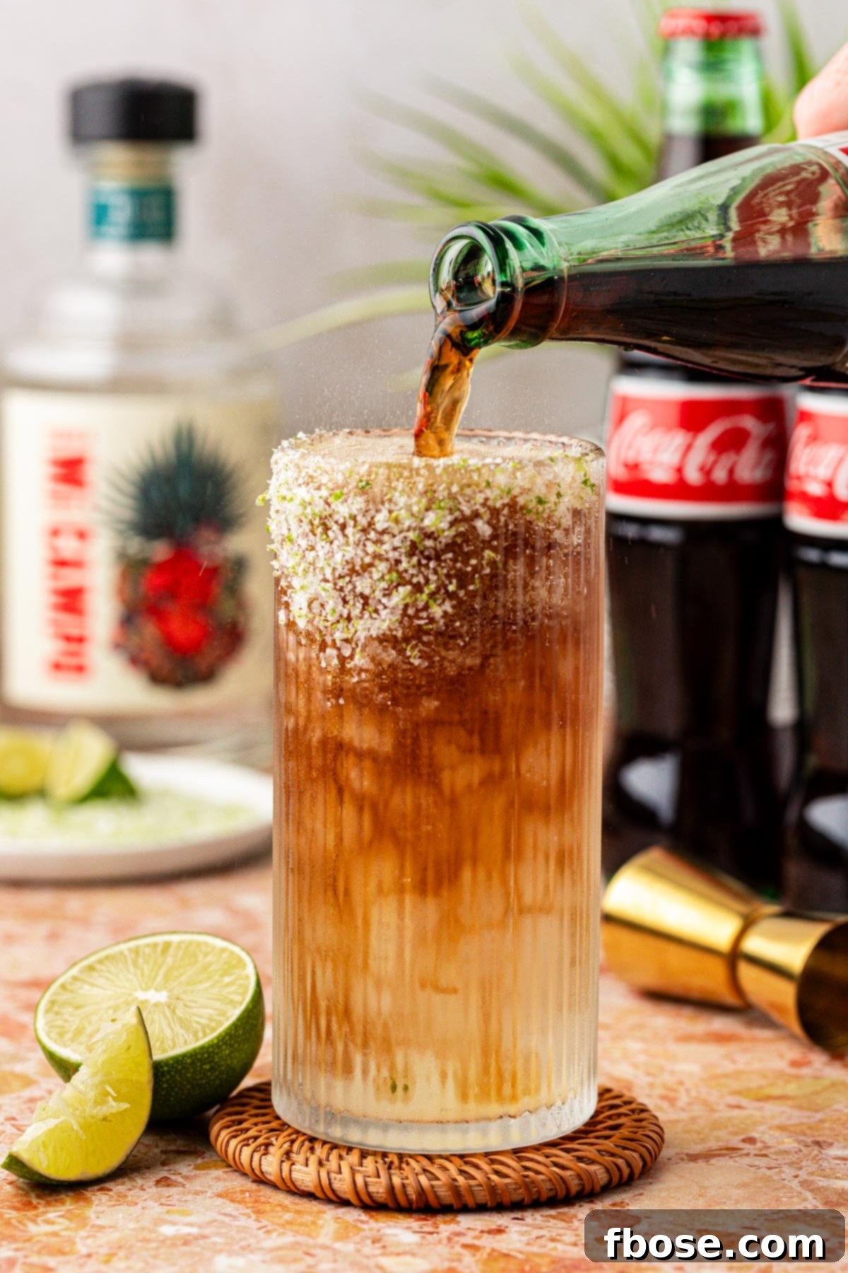 Coke being poured into a glass to make a Batanga.