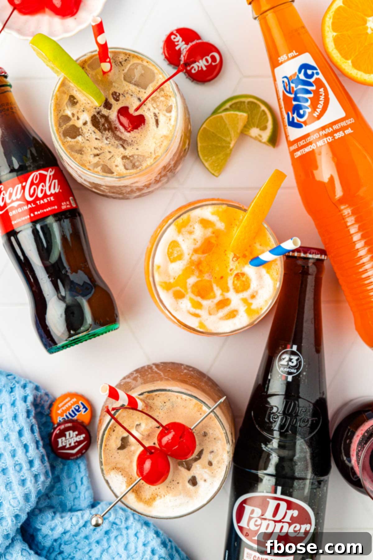 Overhead photo of fluffy sodas and glass bottles of soda on a table.