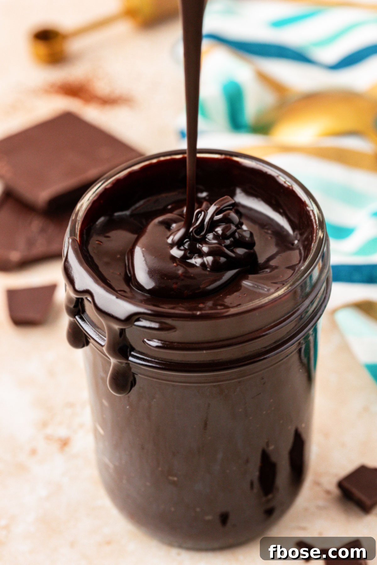 Rich Hot Fudge Sauce 7 Hot fudge being drizzled into a jar.