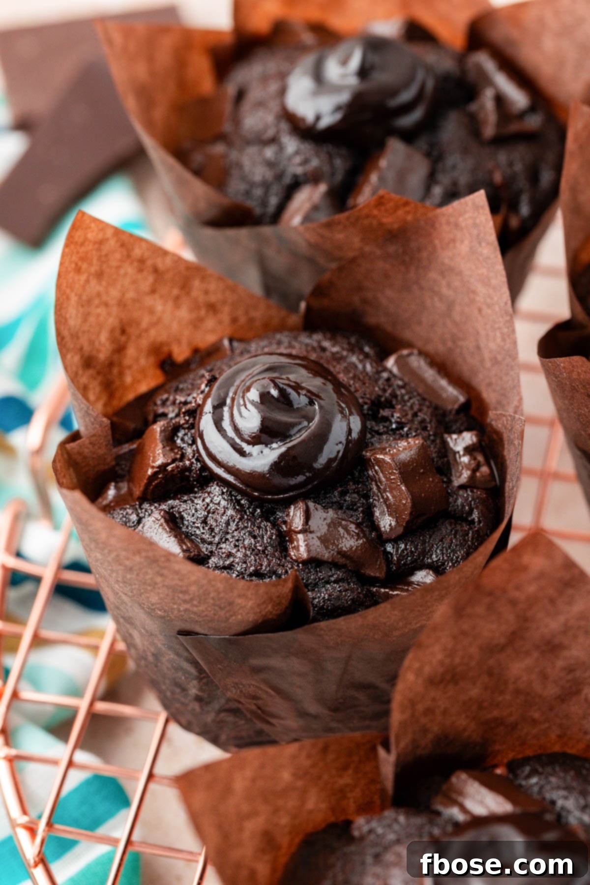 Close up of chocolate chunk muffins inspired by the olympics, showcasing their moist interior and rich chocolate topping.