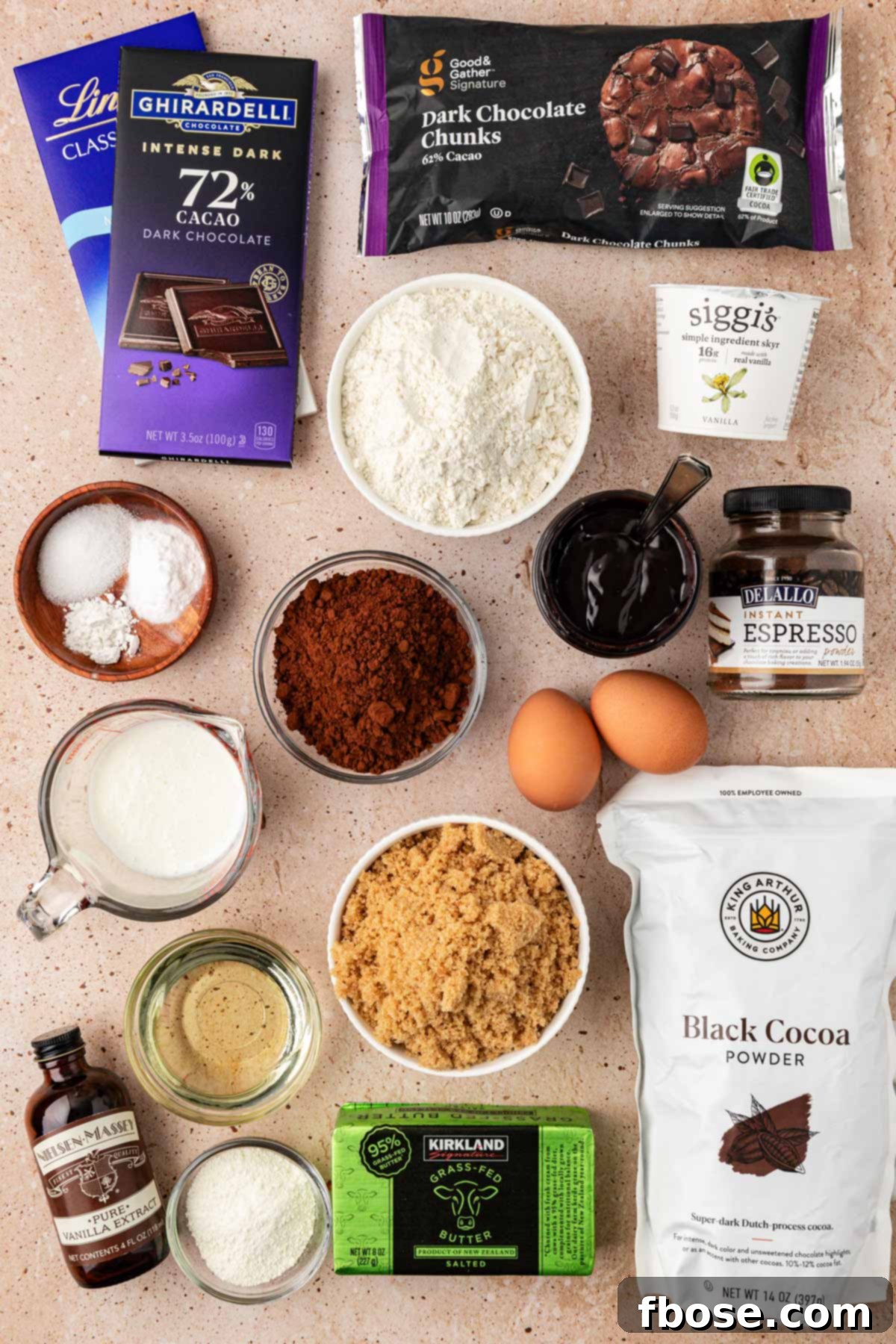 Overhead photo of all the essential ingredients laid out neatly to make Olympic Chocolate Muffins at home, including cocoa powders, flour, eggs, and chocolate.