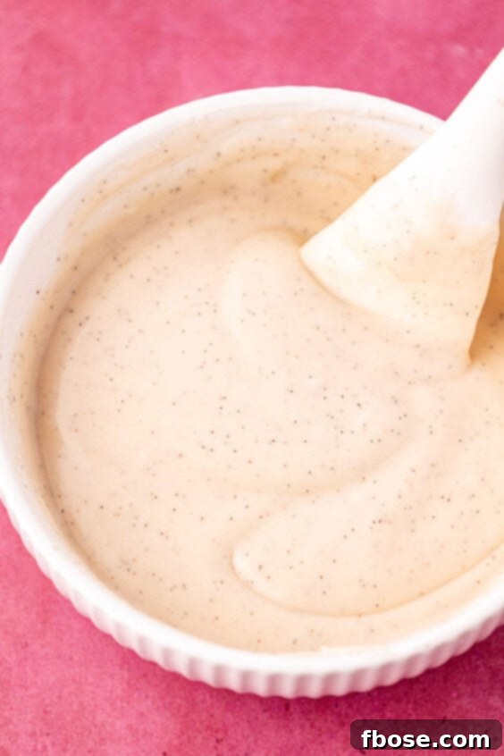 Vanilla icing in a white bowl.