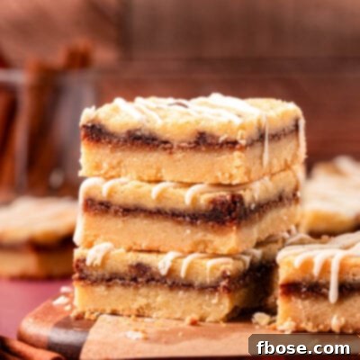 Close up of a stack of three cinnamon roll cookie bars on a table.