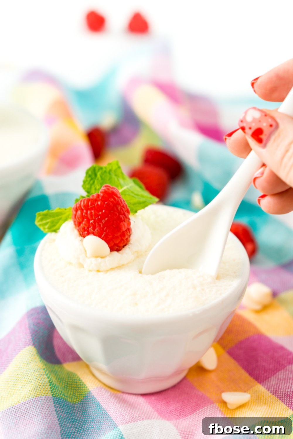 Close-up of fluffy white chocolate mousse served in individual glasses, ready to be garnished.