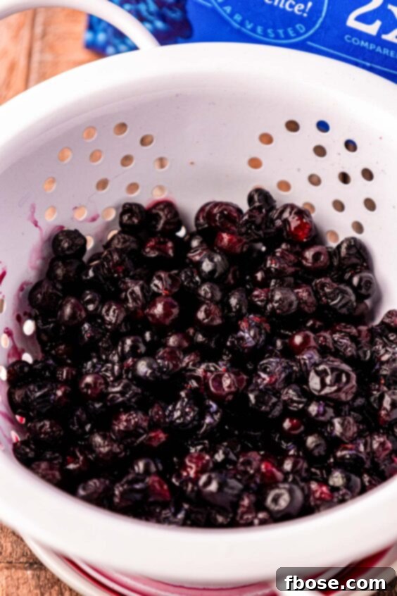 Warm Blueberry Apple Crisp 12 Frozen blueberries in a colander.