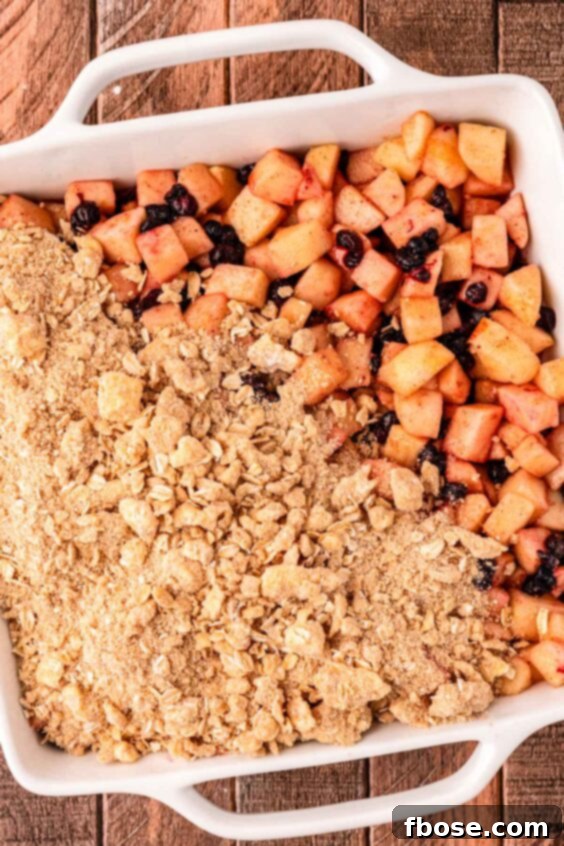 Warm Blueberry Apple Crisp 14 Crisp topping being spread out over apple mixter.