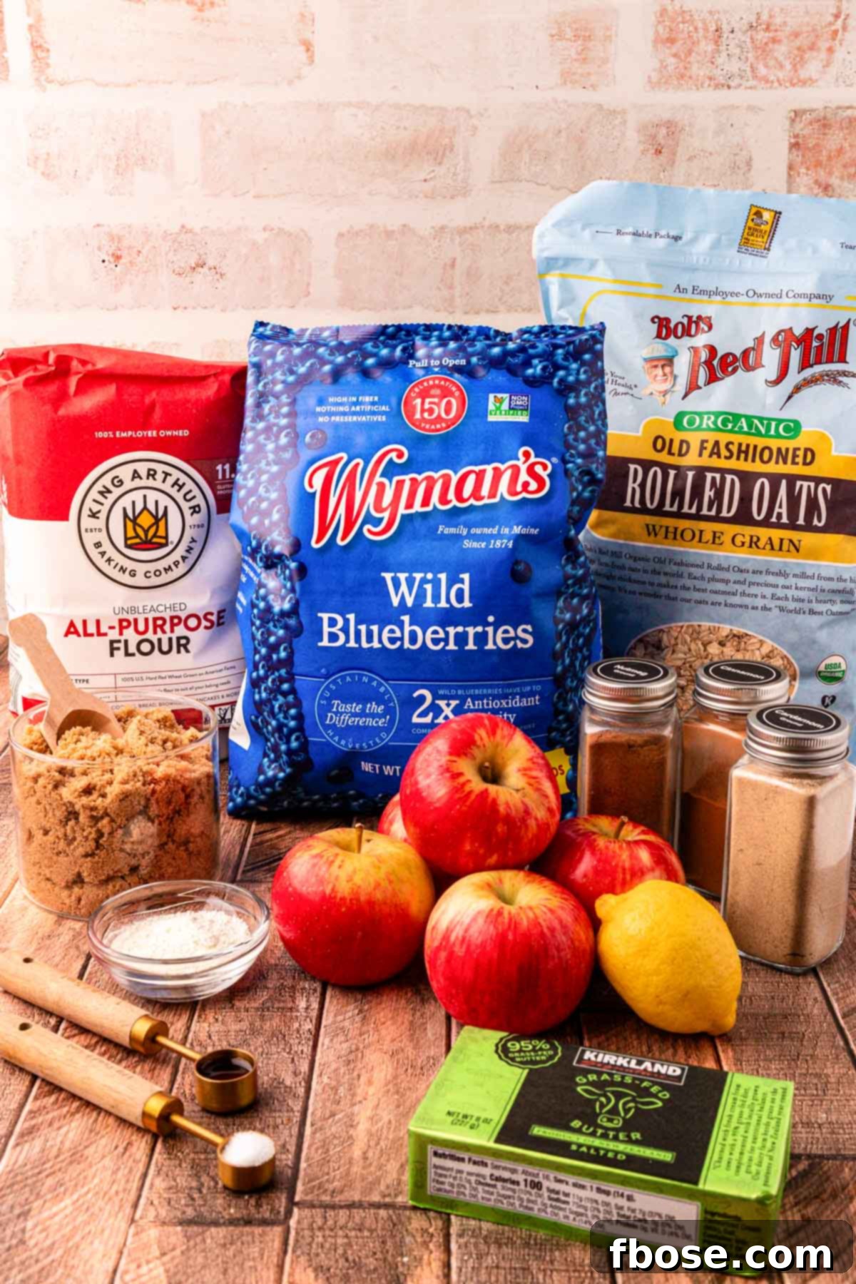 Warm Blueberry Apple Crisp 4 Ingredients for blueberry apple crisp on a wooden table.