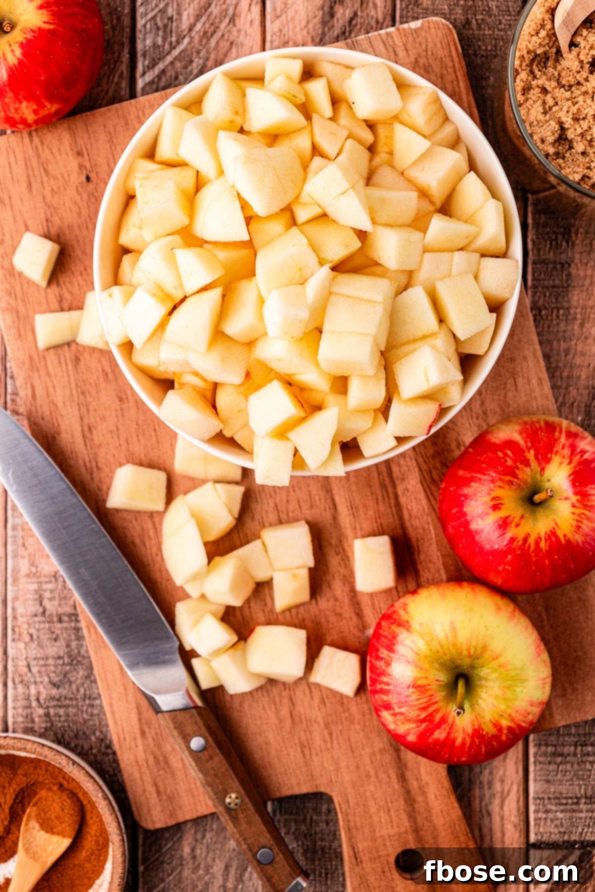Warm Blueberry Apple Crisp 5 Overhead photo of apples being chopped on a cutting board.