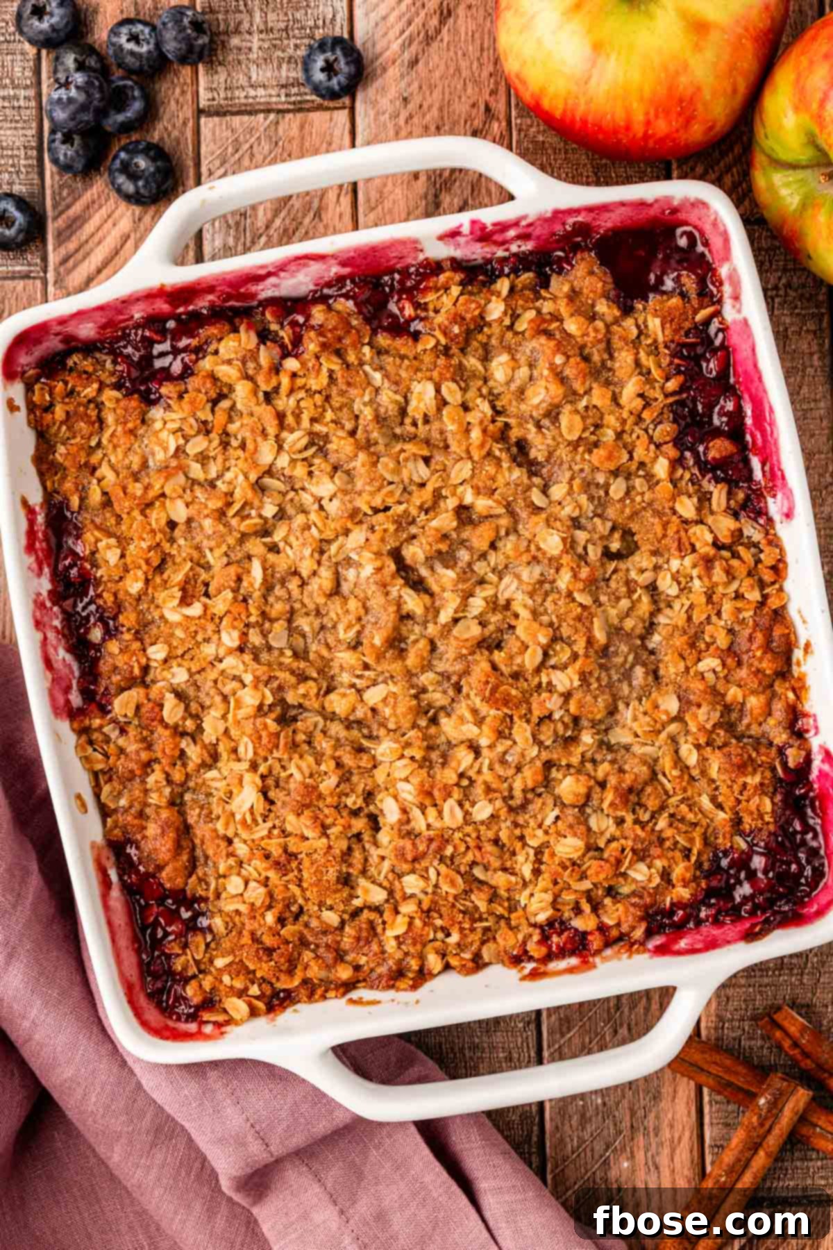 Warm Blueberry Apple Crisp 6 Overhead photo of apple blueberry crisp on a wooden table.